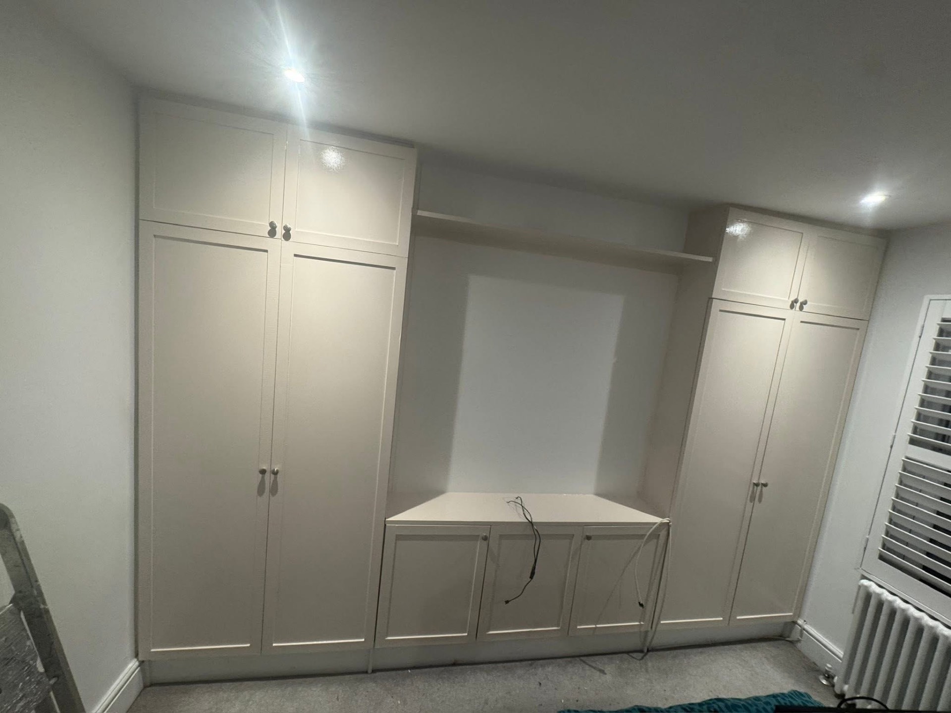 Fitted wardrobes and dressing area finished in a soft white