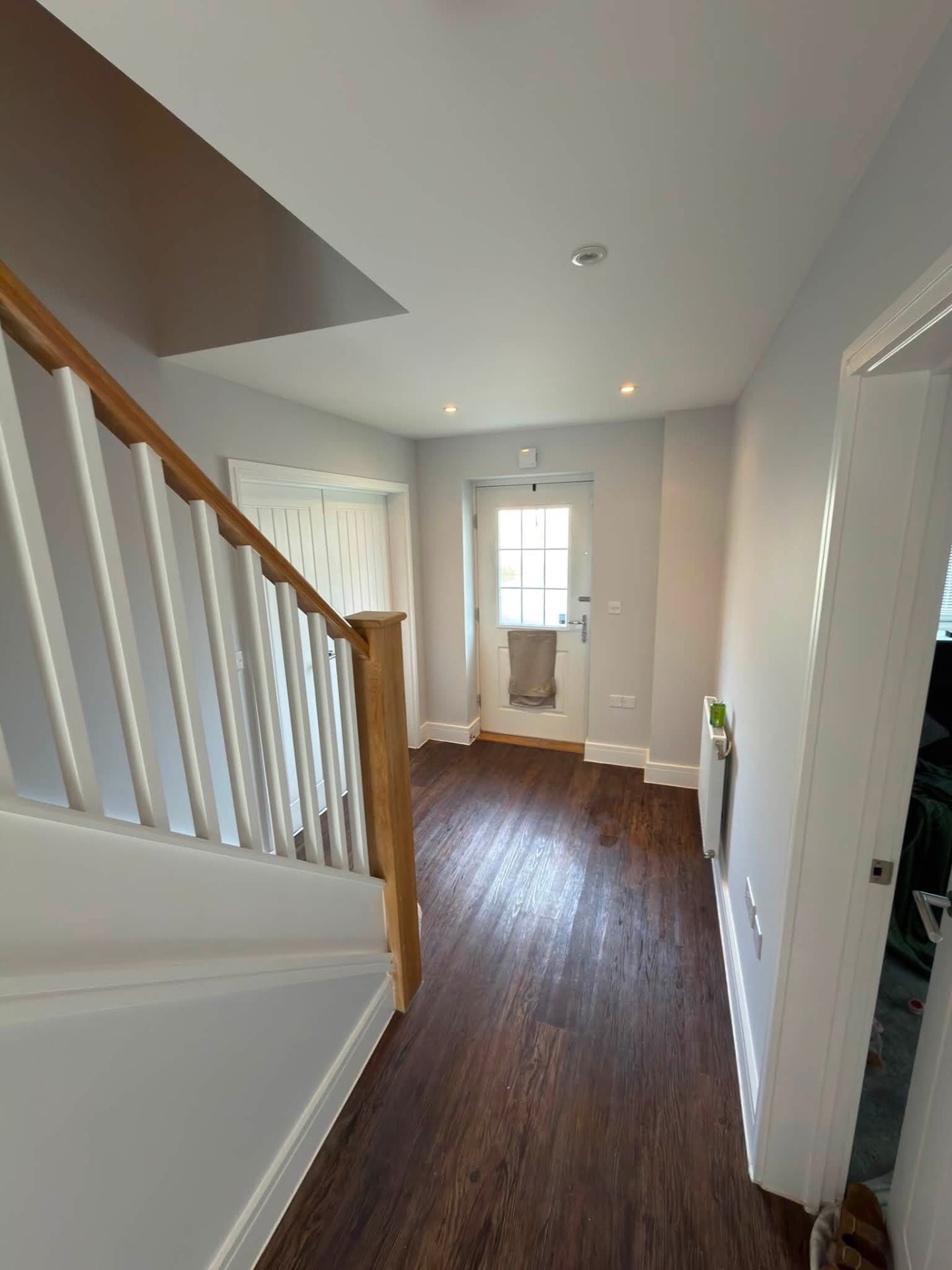 Entrance hall with freshly painted spindles, handrail and doors