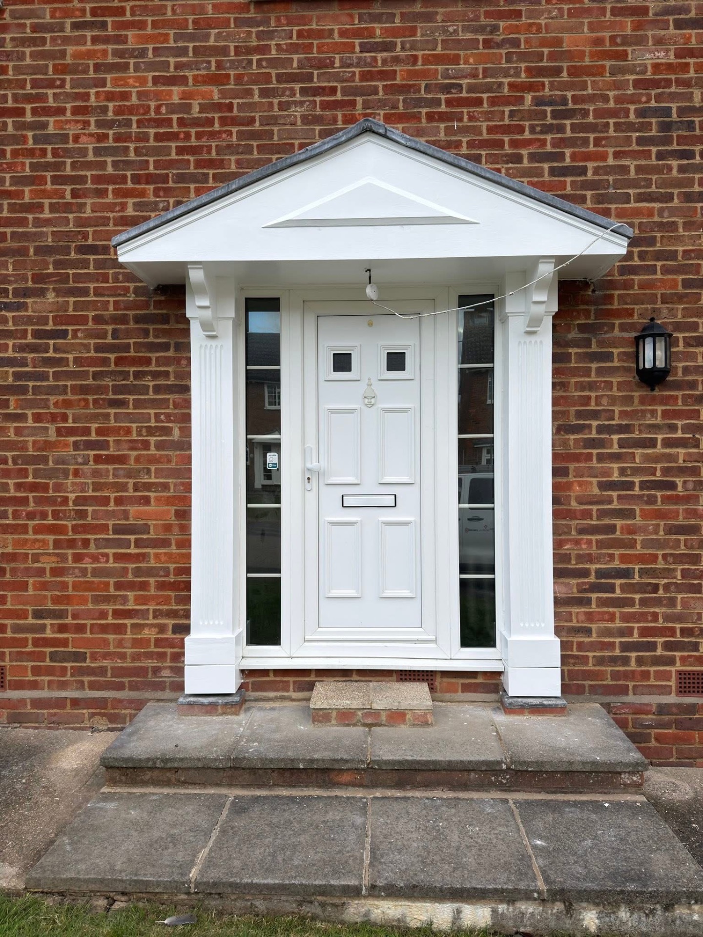 Front porch, columns and canopy repainted in bright exterior white